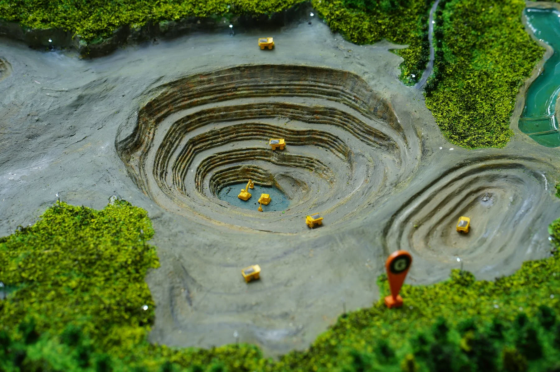 Close-up of Amman Mineral mining basin with stepped excavation.