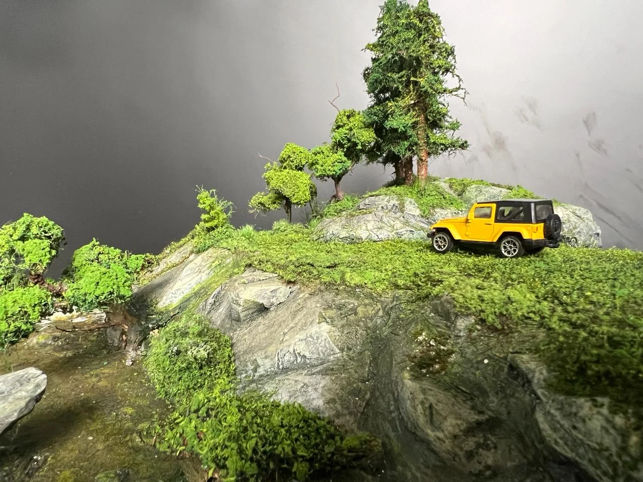 Miniature road and yellow vehicle detail in the English Countryside Diorama.