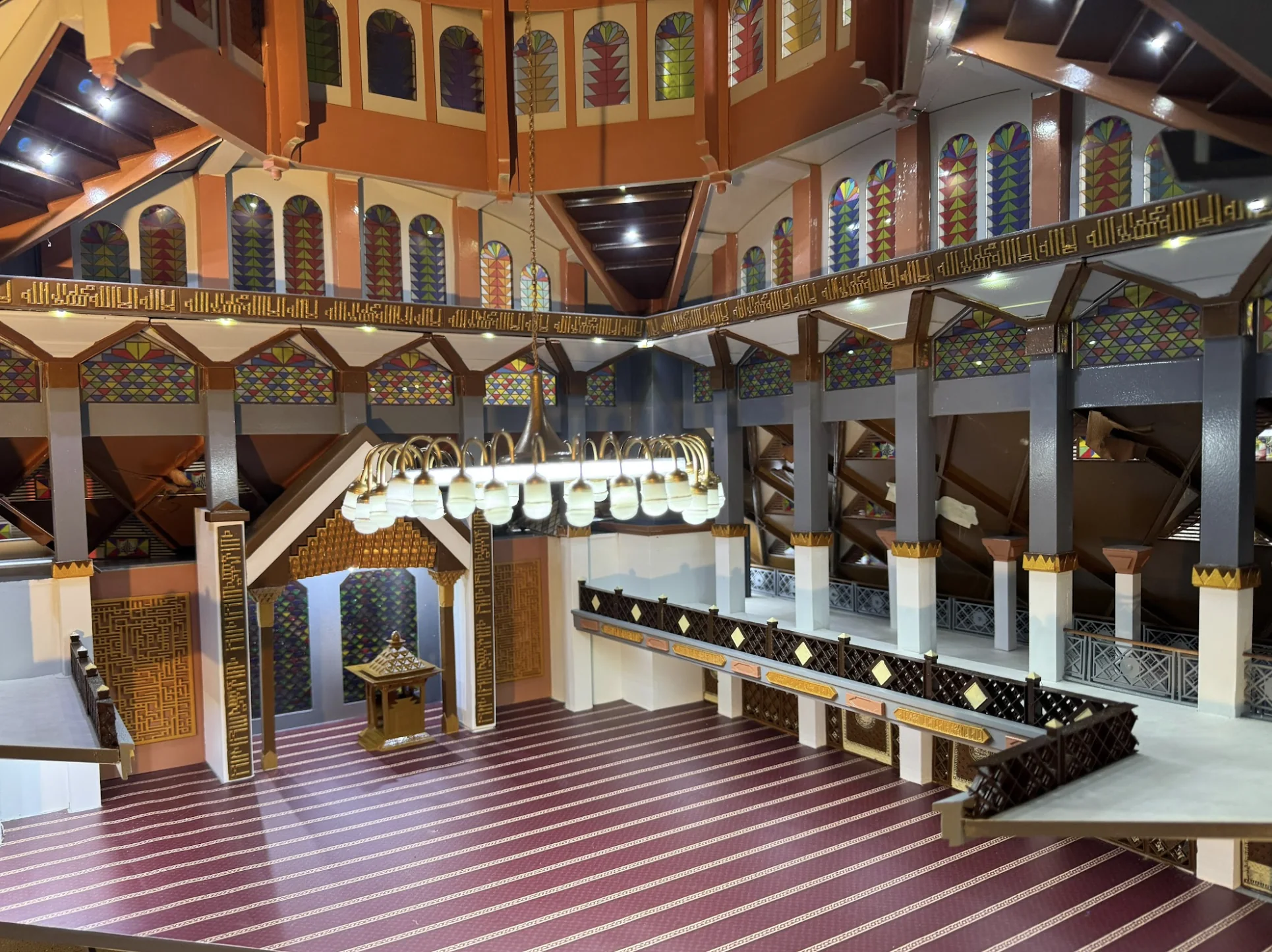 Wide interior detail of Masjid Raya Bogor model with chandelier, stained glass, and ornament.